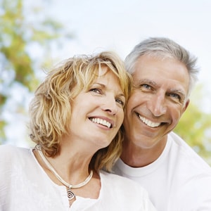 Older couple smiling because of quality New York Dental treatments