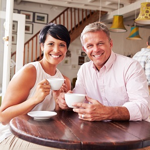 Older couple smiling because of quality New York cosmetic dental treatments
