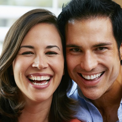 Older couple smiling because of quality New York Dental treatments